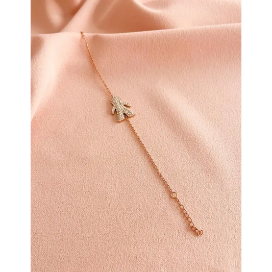 PULSERA EN ACERO CON DIJE DE NIÑO TONO ORO ROSA